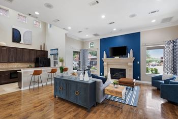 A living room with a blue accent wall and a fireplace